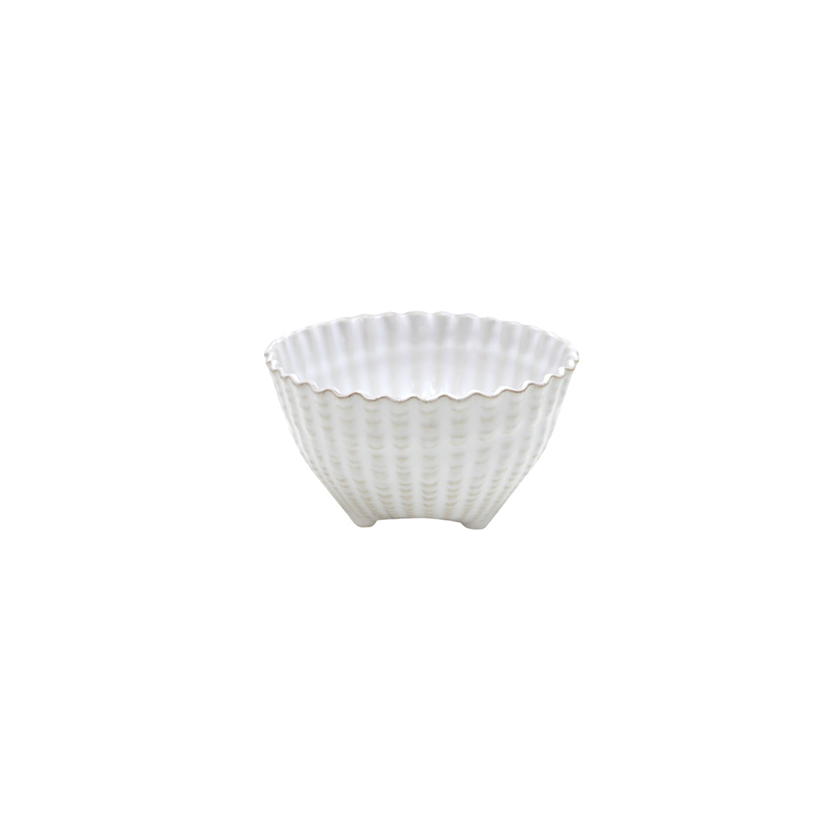 A small white ceramic bowl with a scalloped, wavy rim and ribbed shell-like texture stands on three short feet.